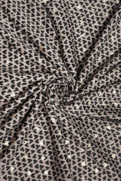 Black and gold heart print fabric in a swirl pattern