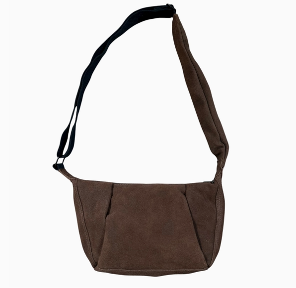 Brown suede shoulder bag with a black strap on a white background