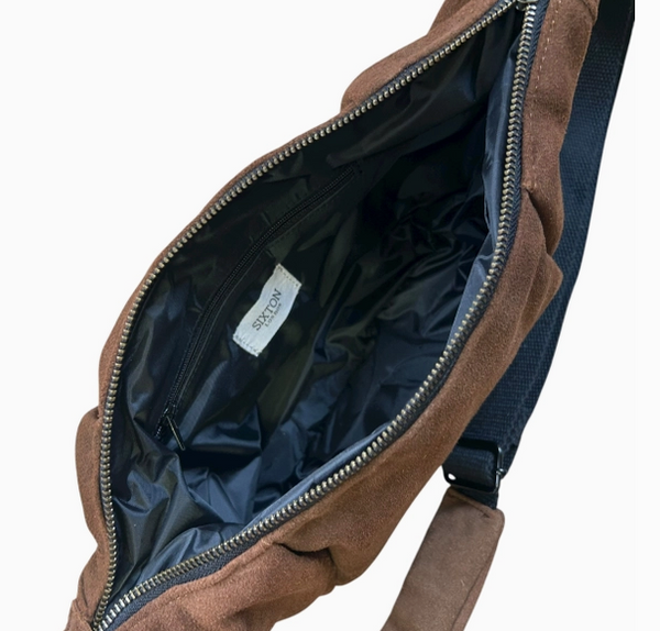 Brown suede leather bag with open zip on a white background