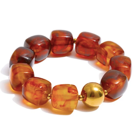 Brown and gold large beaded bracelet on a white background