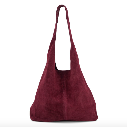 A slouchy hobo shoulder bag made of deep burgundy suede, photographed against a seamless white background.