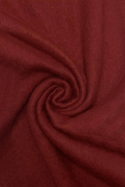 Close-up of burgundy fabric with a swirl pattern