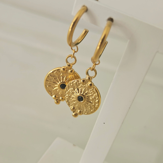 gold disc earrings on a white background