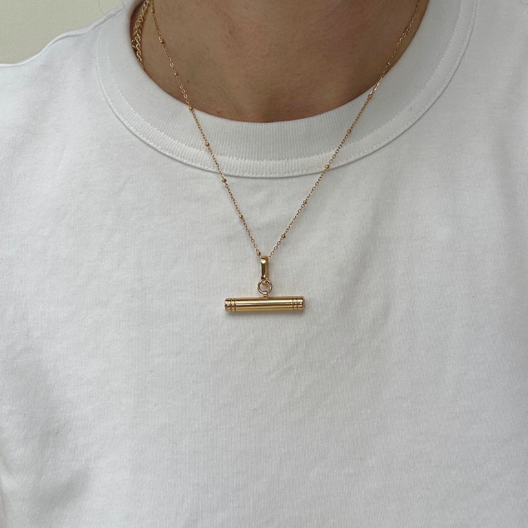 woman in white t-shirt with a gold T-bar necklace