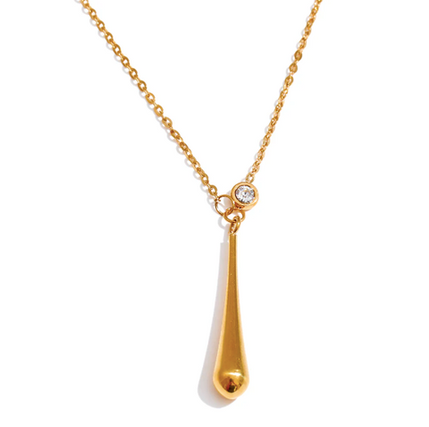 Gold teardrop necklace with a crystal detail on a fine chain with a white background