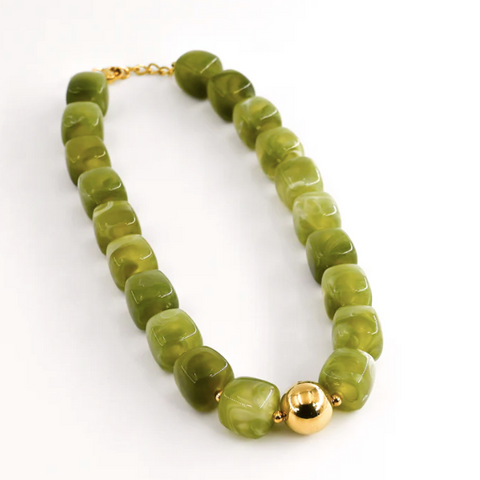 Green beaded necklace with a gold clasp on a white background