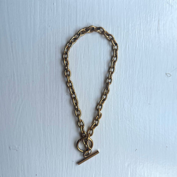 SAMPLE Gold coloured t-bar chain bracelet.