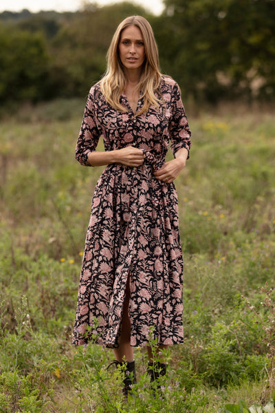 Woman in a floral dress standing in a field