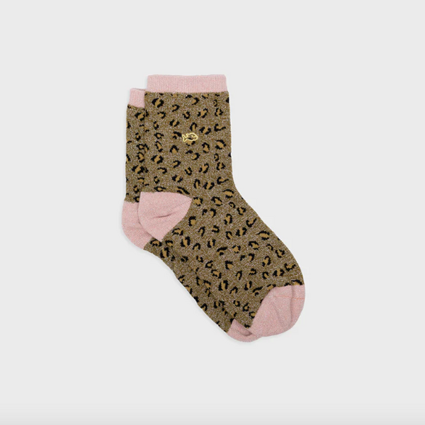 green Socks with leopard print and pink accents on a light gray background