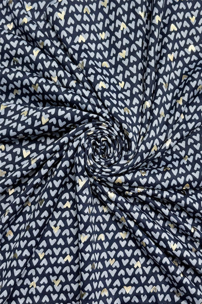 Navy blue fabric with white heart pattern, rolled up