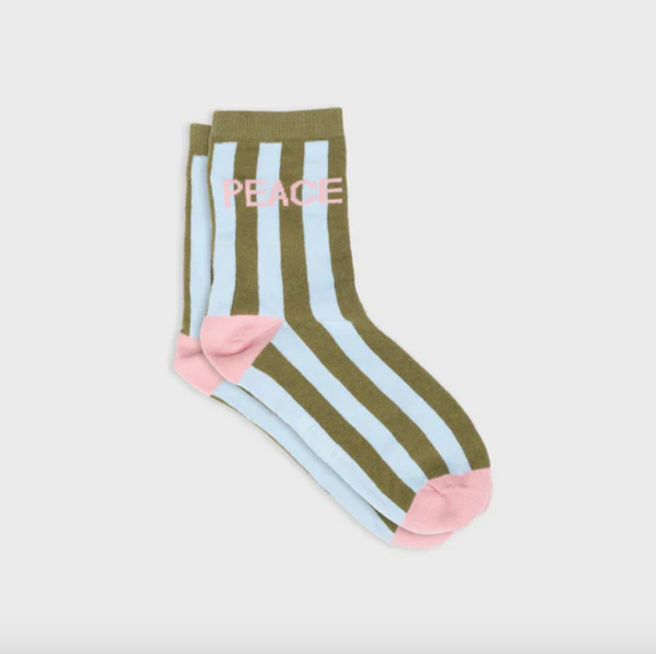 Striped socks with 'PEACE' text on a light gray background
