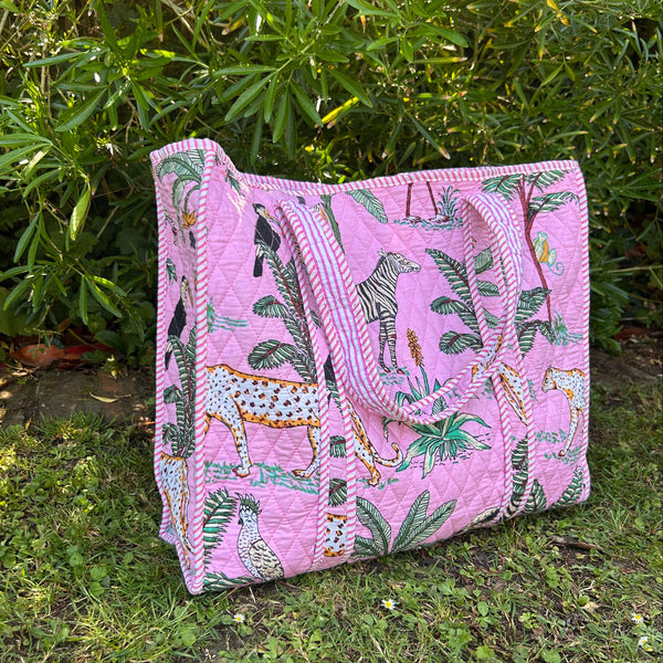 Pink tote bag with animal print on grass