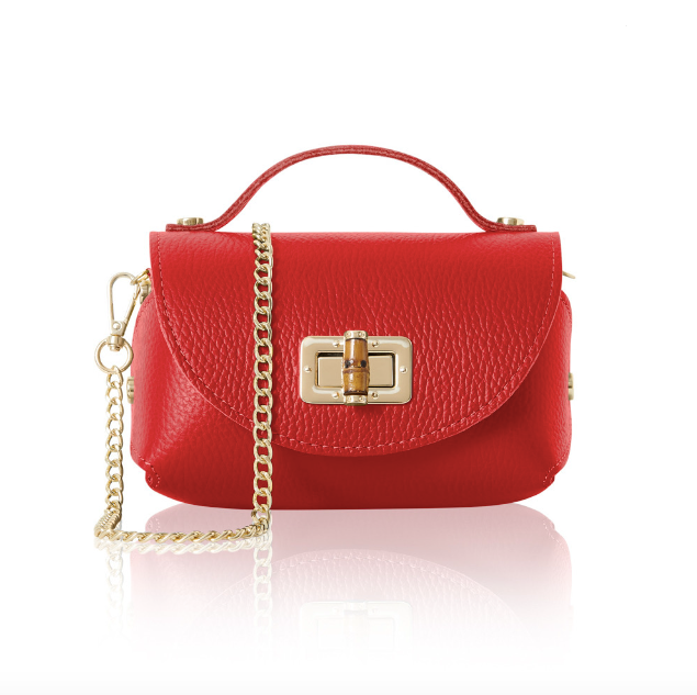 Red handbag with a gold chain and bamboo style clasp on a white background