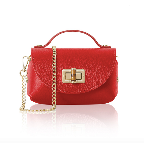 Red handbag with a gold chain and bamboo style clasp on a white background
