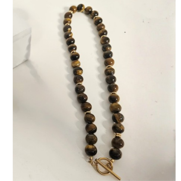 Beaded necklace with a gold t-bar clasp on a white background