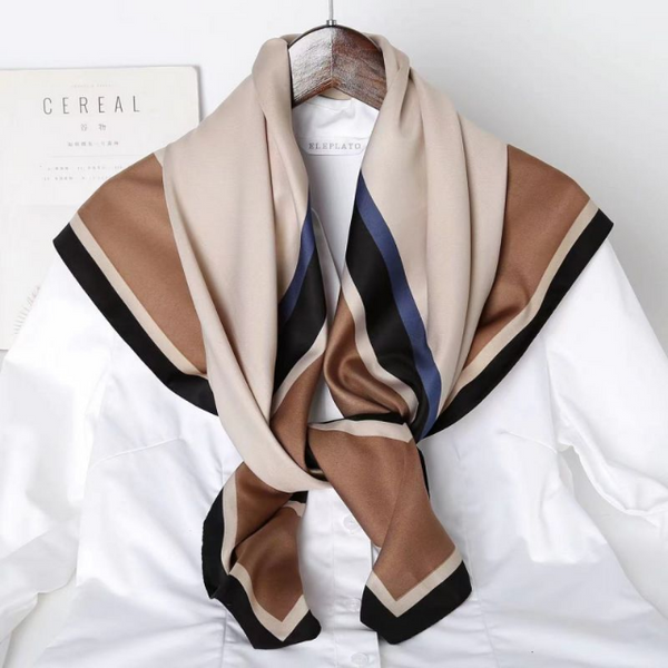 Neatly folded scarf with brown, beige, and black stripes on a white background