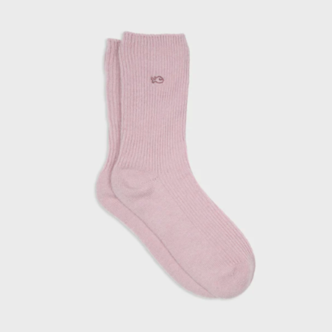 Pink sock with a brand logo on a light gray background