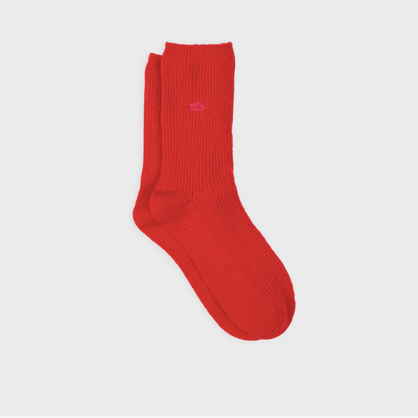 Red sock with a brand logo on a light gray background