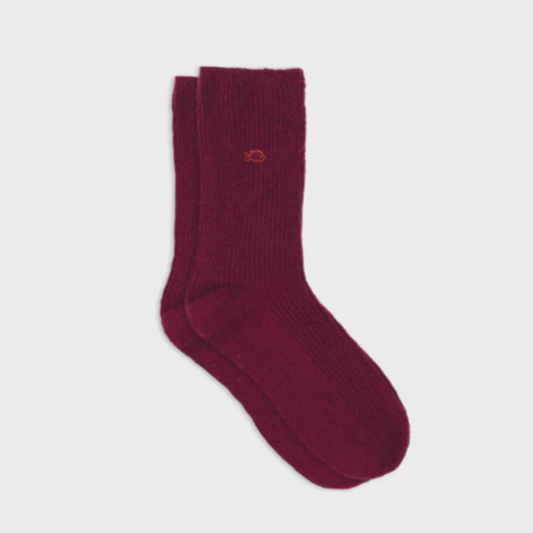 Maroon sock with a logo on a light gray background