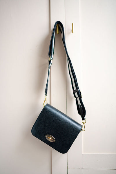 Black Leather Crossbody Lock Bag with monochrome strap