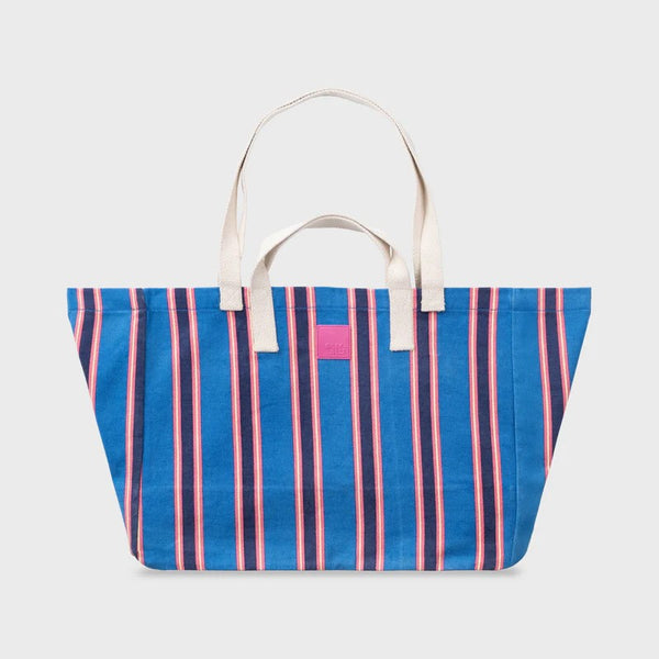 Blue and pink striped tote bag with a pink flag on a white background