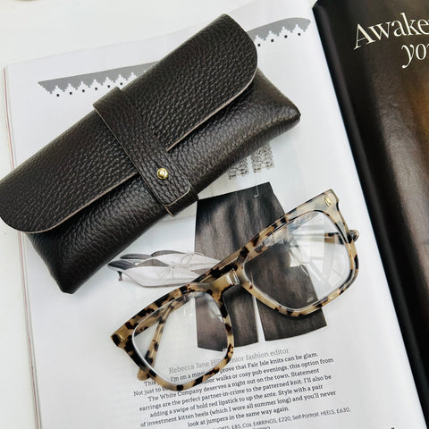 Chocolate Brown leather glasses case on a magazine with tortoiseshell glasses