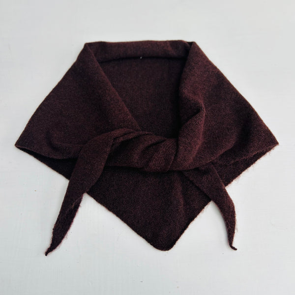 Brown knotted triangle scarf on a light gray background
