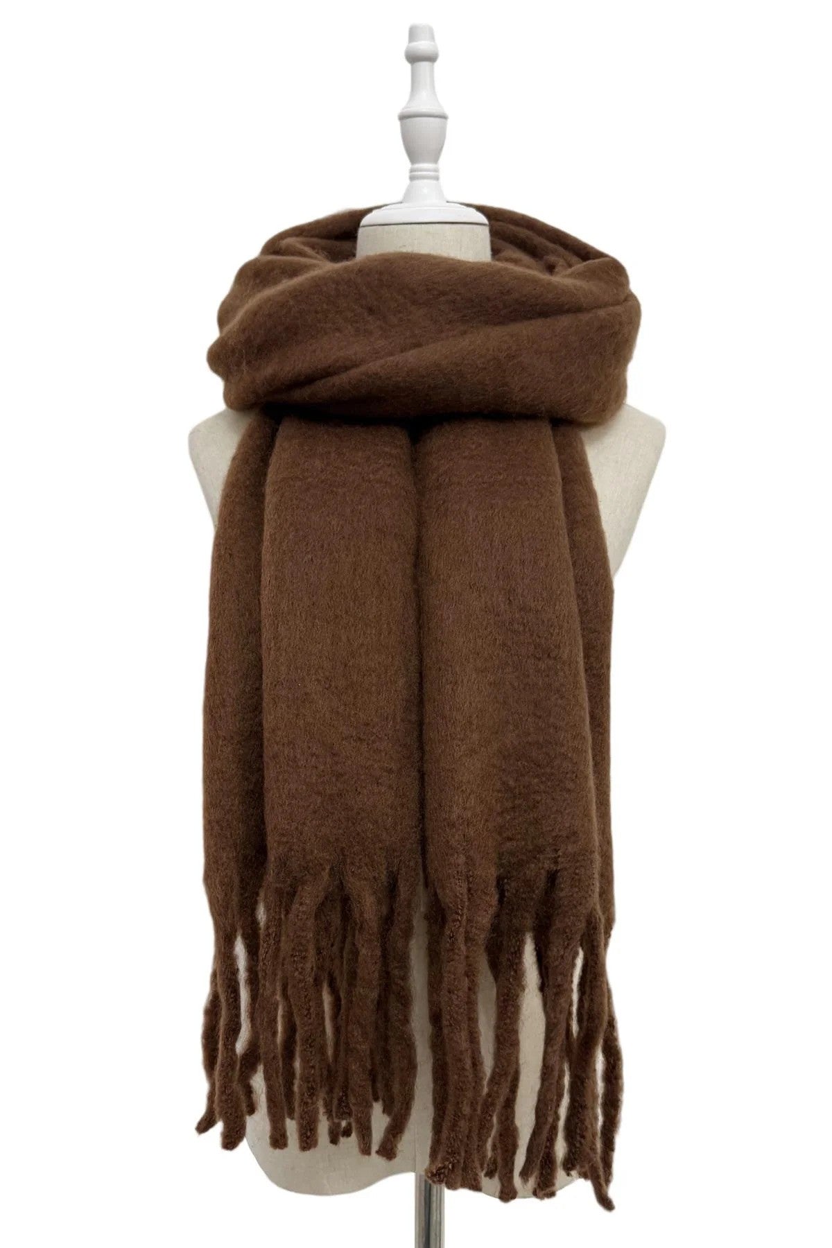 Brown scarf with tassels on a mannequin against a white background