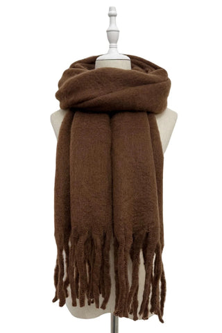 Brown scarf with tassels on a mannequin against a white background