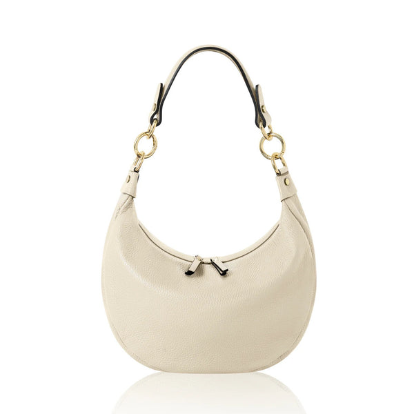 Cream leather bag with gold hardware on a white background