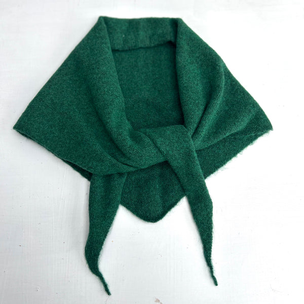 green knotted wool scarf on a white background