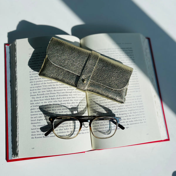 Gold Leather Glasses Case with ace and tate glasses and book