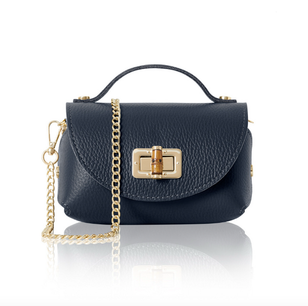 Navy blue mini handbag with gold chain and bamboo style clasp on a white background