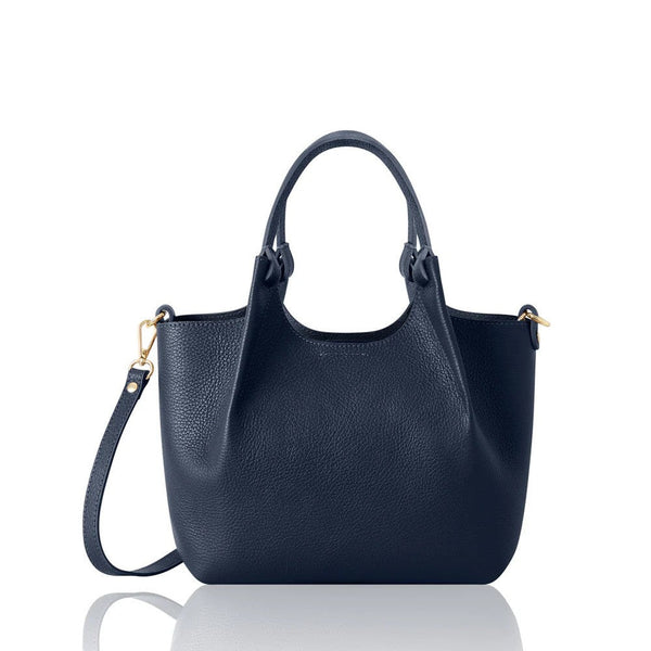 navy structured leather bag with top handle and crossbody trap on a white background