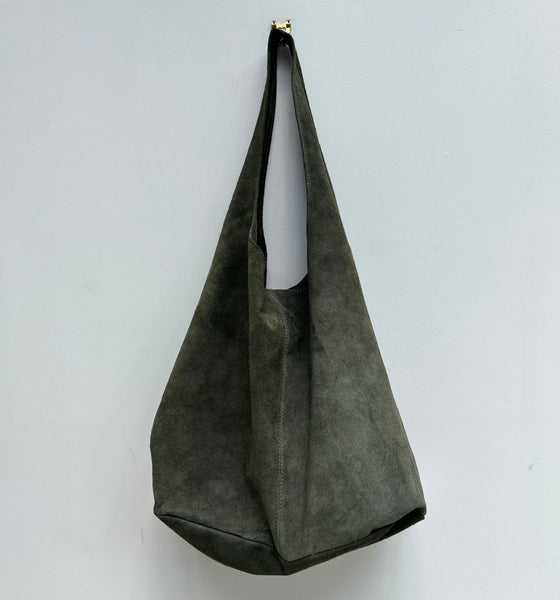 olive green suede shoulder bag on a light gray background