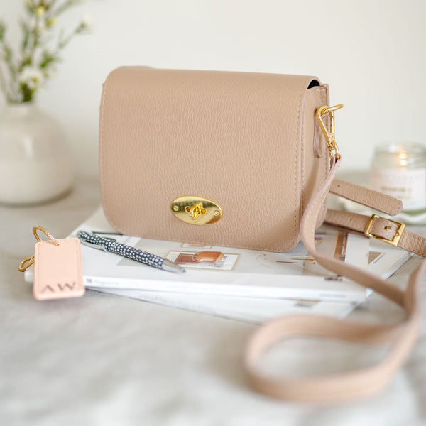 Rose Pink Leather Lock Crossbody Bag with slim strap. By AnySomething Photography