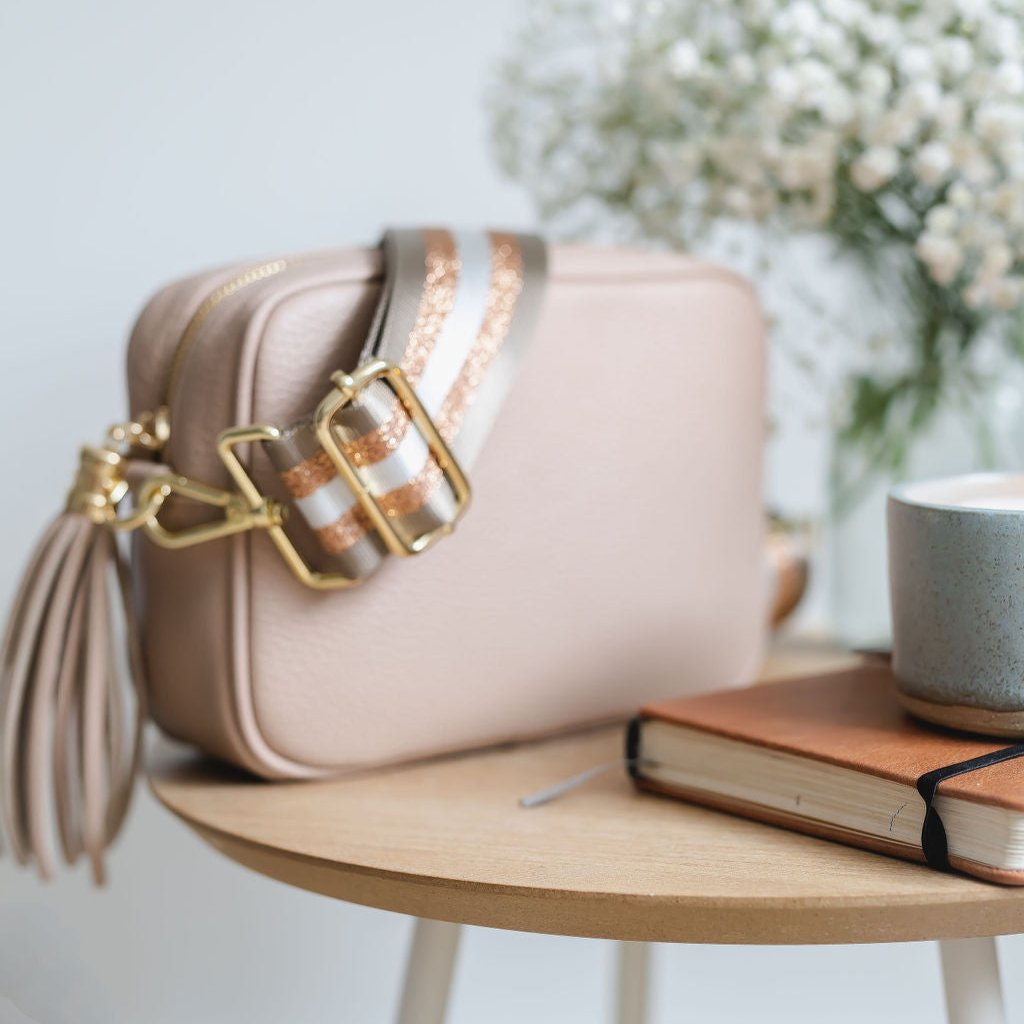 Rose Pink Leather Tassel Cross Body Bag with rose gold and taupe stripe bag strap