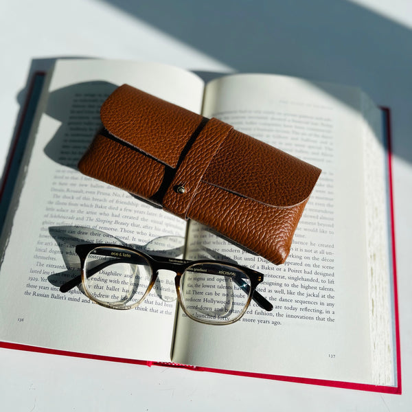 Tan Leather Glasses Case with ace and tate glasses on book