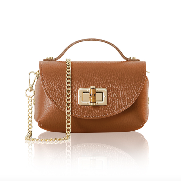 Brown handbag with a gold chain and bamboo style clasp on a white background