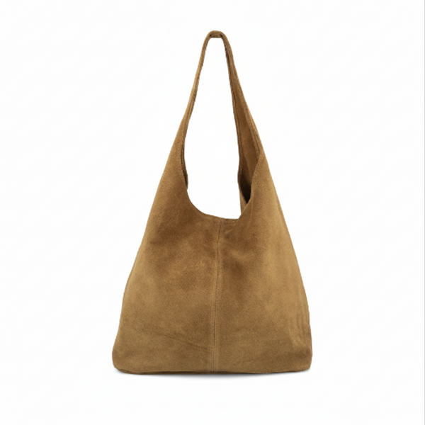 Tan suede handbag on a white background