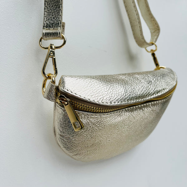 Gold Leather Waist Crossbody Bag hanging from slim strap