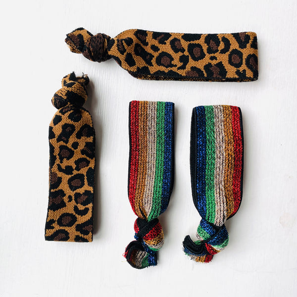 rainbow and leopard print hair elastics on a white background